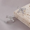 Xuhui brand exquisite and light luxury copper plated with real gold and set with zircon 925 silver needle bow, luxurious and fashionable stud earrings Application Scenario